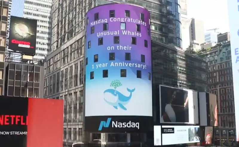 The Nasdaq tower in Times Square displaying the message Nasdaq congratulates Unusual Whales on their 1 year anniversary, with the Unusual Whales whale logo